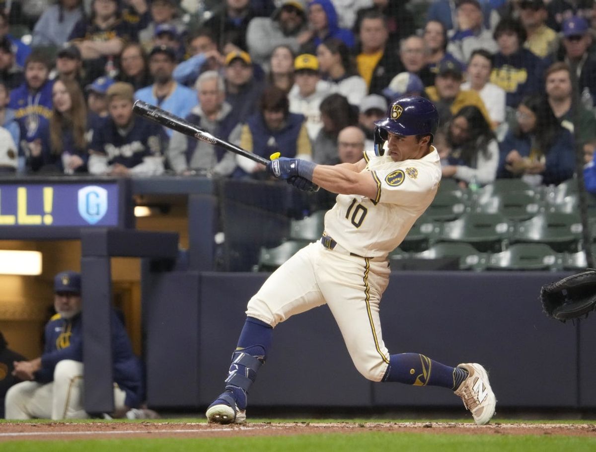 Apr 3, 2025; Milwaukee, Wisconsin, USA; Milwaukee Brewers outfielder Sal Frelick (10) drives in a run against the Cincinnati Reds in the fourth inning at American Family Field. Mandatory Credit: Michael McLoone-Imagn Images