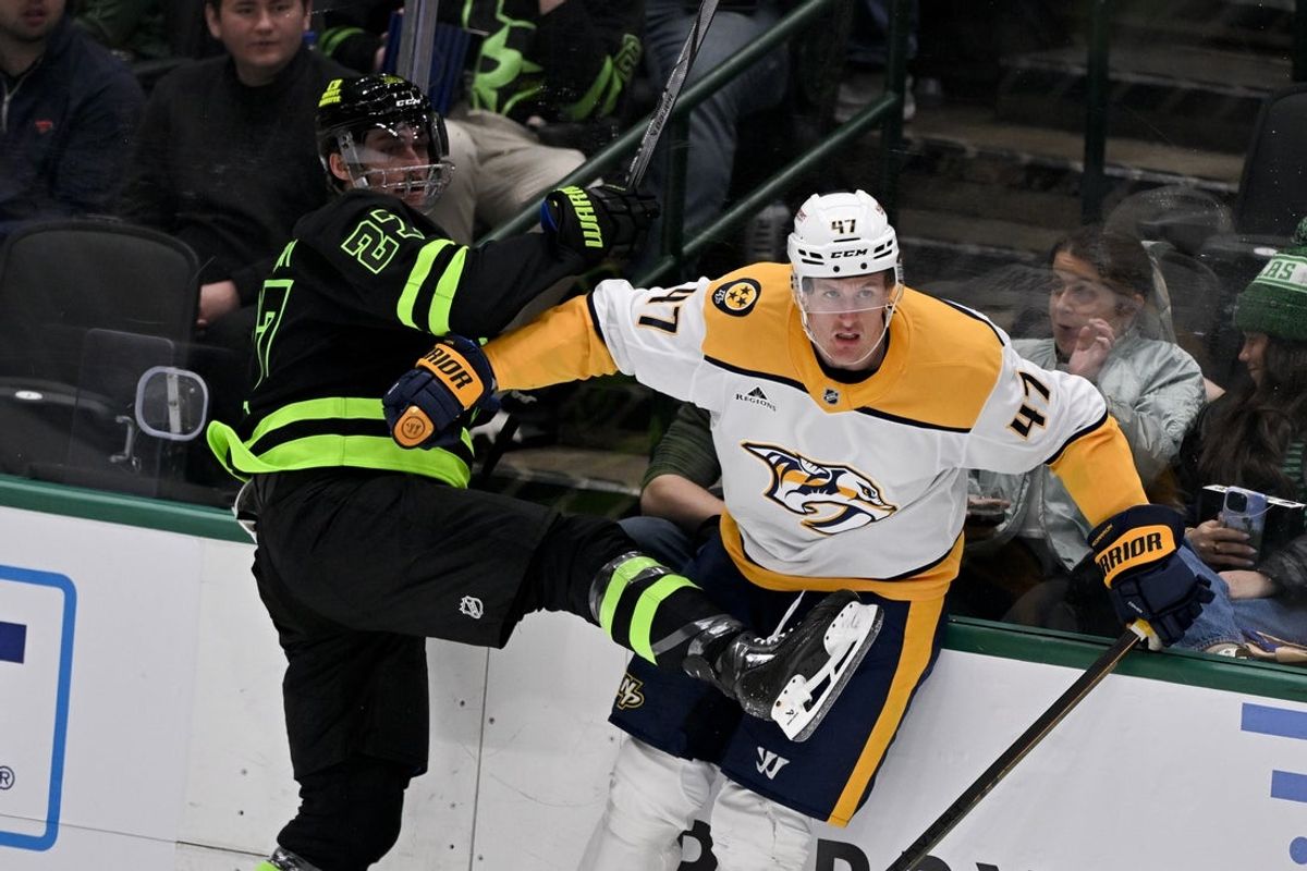 Apr 3, 2025; Dallas, Texas, USA; Dallas Stars left wing Mason Marchment (27) checks Nashville Predators right wing Michael McCarron (47) during the second period at the American Airlines Center. Mandatory Credit: Jerome Miron-Imagn Images