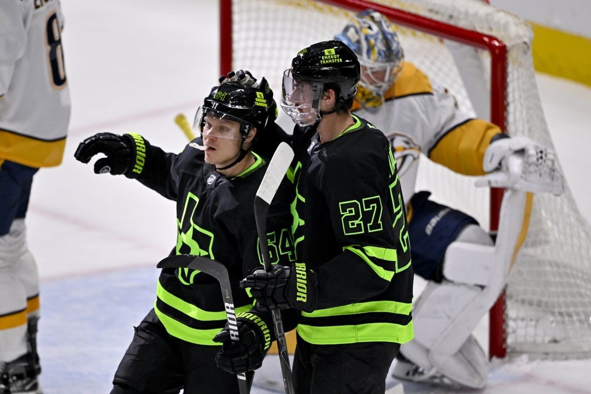 Apr 3, 2025; Dallas, Texas, USA; Dallas Stars center Mikael Granlund (64) and left wing Mason Marchment (27) celebrates Granlund scoring a goal against Nashville Predators goaltender Justus Annunen (29) during the second period at the American Airlines Center. Mandatory Credit: Jerome Miron-Imagn Images