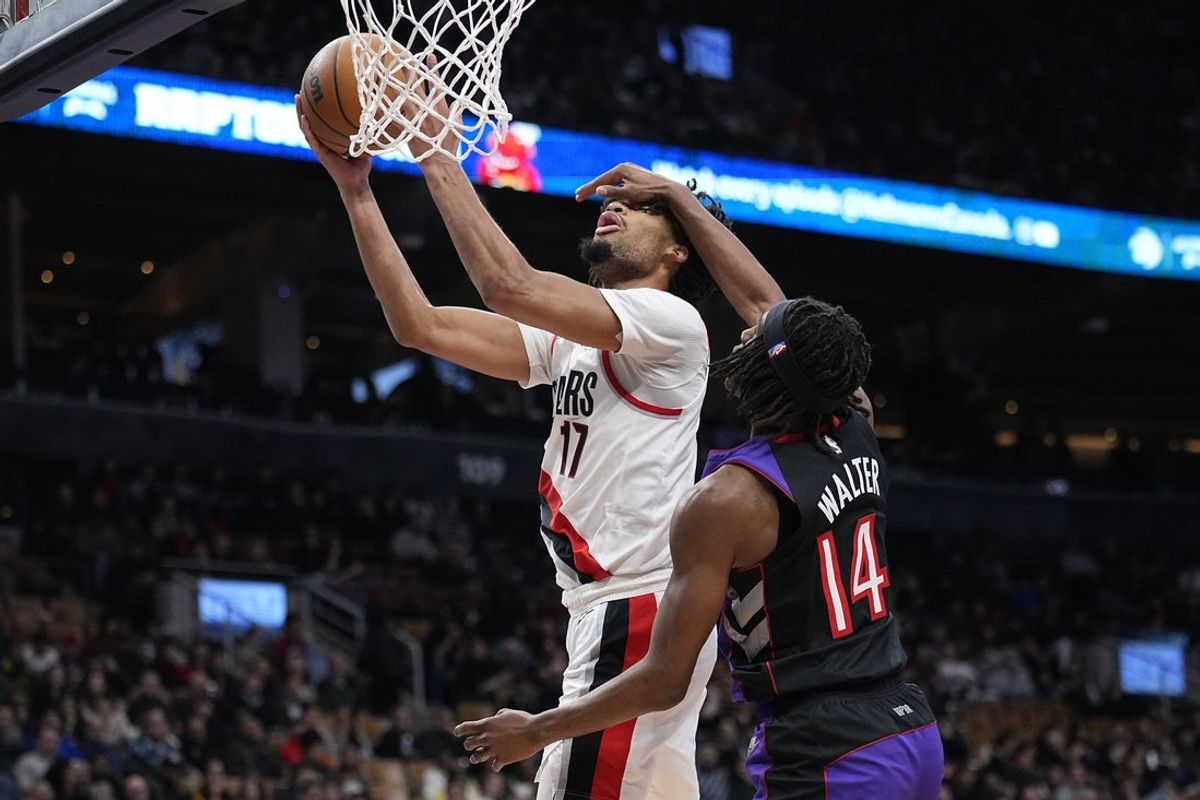 Apr 3, 2025; Toronto, Ontario, CAN; Portland Trail Blazers guard Shaedon Sharpe (17) gets fouled by Toronto Raptors guard Ja'Kobe Walter (14) as he goes up to make a basket during the second half at Scotiabank Arena. Mandatory Credit: John E. Sokolowski-Imagn Images