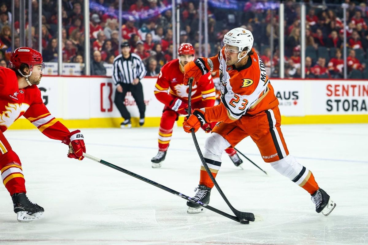 Apr 3, 2025; Calgary, Alberta, CAN; Anaheim Ducks center Mason McTavish (23) shoots the puck against the Calgary Flames during the first period at Scotiabank Saddledome. Mandatory Credit: Sergei Belski-Imagn Images