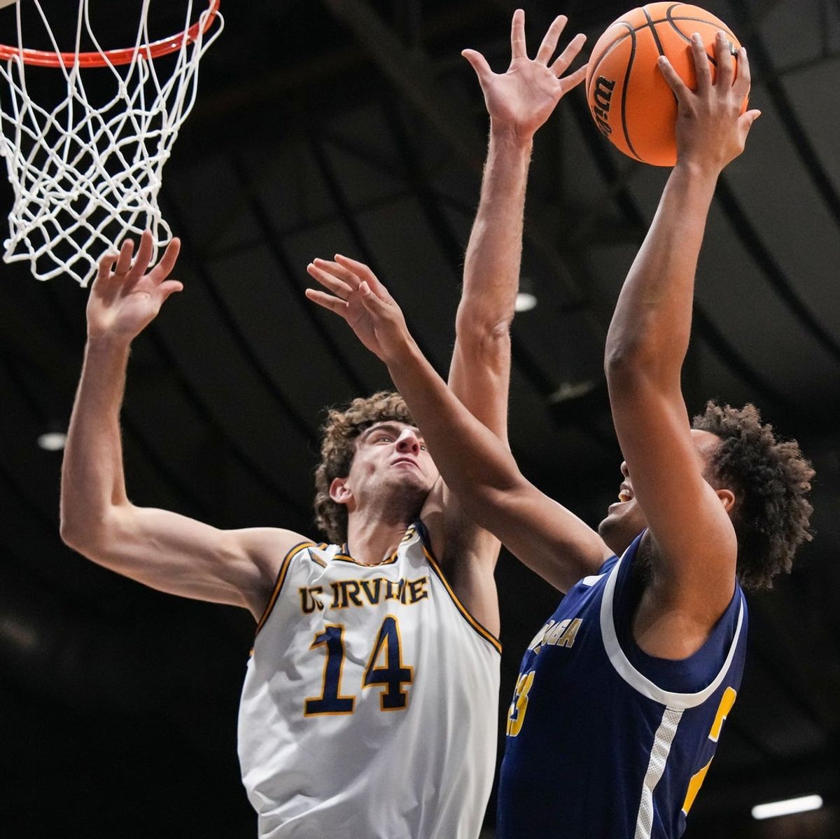 Chattanooga Mocs forward Latif Diouf (23) goes in for a lay-up against UC Irvine Anteaters forward Kyle Evans (14) on Thursday, April 3, 2025, during the National Invitional Tournament at Hinkle Fieldhouse in Indianapolis.