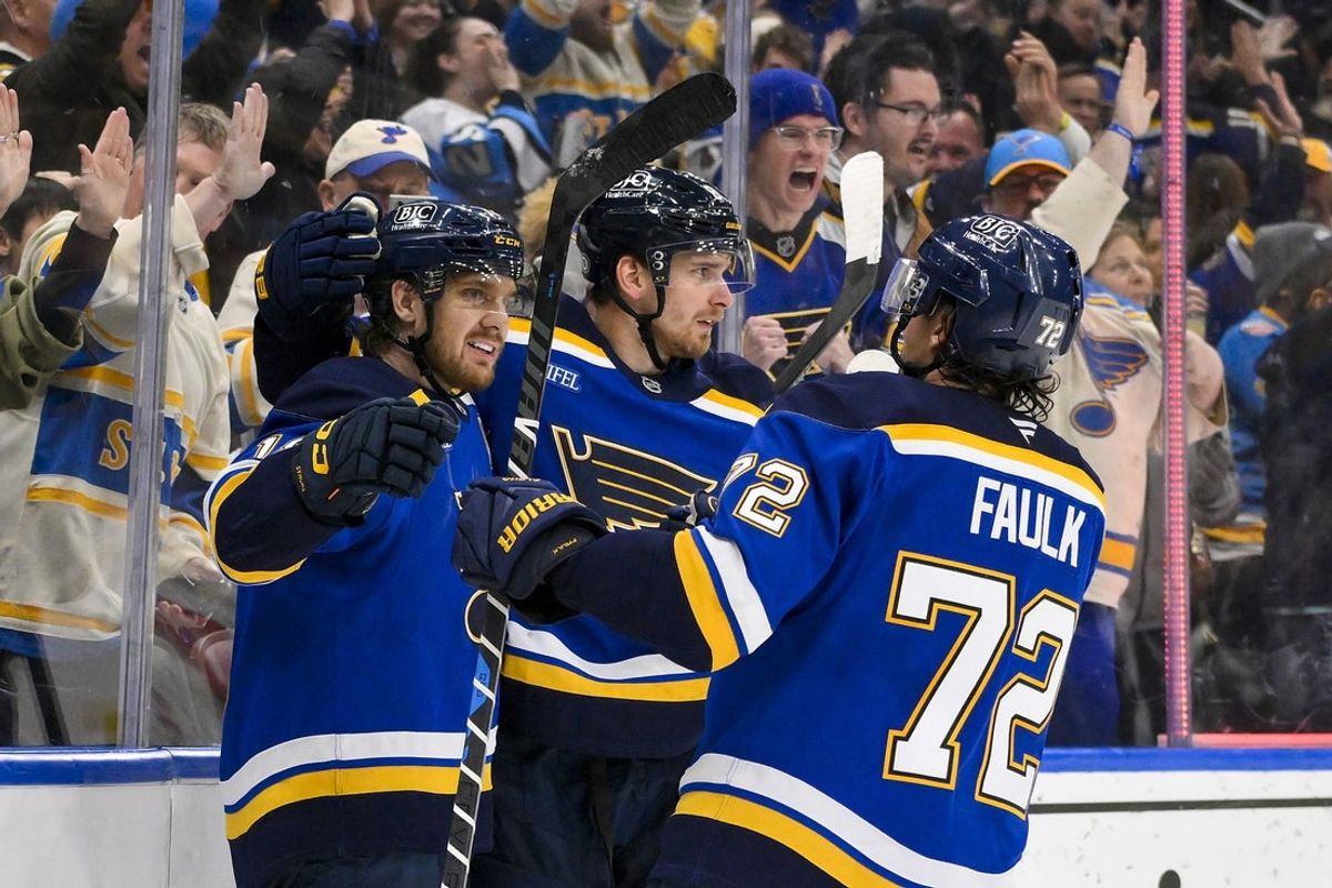 Apr 3, 2025; St. Louis, Missouri, USA;  St. Louis Blues center Robert Thomas (18) celebrates with left wing Pavel Buchnevich (89) and defenseman Justin Faulk (72) after scoring the game winning goal against the Pittsburgh Penguins during overtime at Enterprise Center. Mandatory Credit: Jeff Curry-Imagn Images