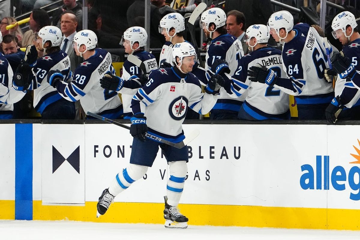 Apr 3, 2025; Las Vegas, Nevada, USA; Winnipeg Jets defenseman Colin Miller (6) celebrates along his bench after scoring a goal against the Vegas Golden Knights during the second period at T-Mobile Arena. Mandatory Credit: Stephen R. Sylvanie-Imagn Images