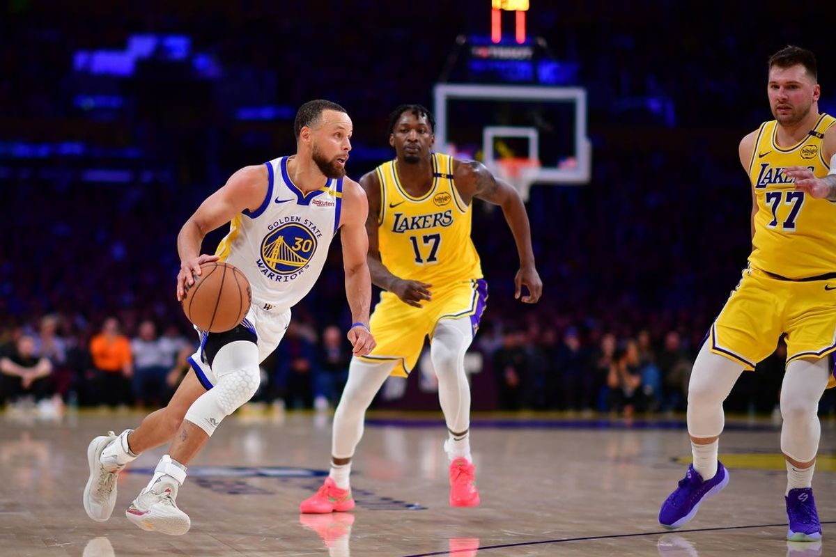 Apr 3, 2025; Los Angeles, California, USA; Golden State Warriors guard Stephen Curry (30) moves to the basket agianst Los Angeles Lakers forward Dorian Finney-Smith (17) and guard Luka Doncic (77) during the second half at Crypto.com Arena. Mandatory Credit: Gary A. Vasquez-Imagn Images