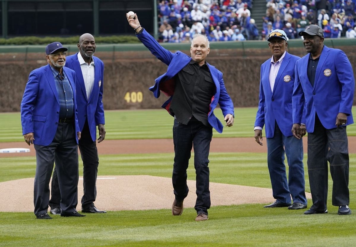 Apr 4, 2025; Chicago, Illinois, USA; L-R Billy Williams Lee Smith Ryne Sandberg, Ferguson Jenkins and Andre Dawson Sandberg, throws out a ceremonial first pitch before the game between the Chicago Cubs and the San Diego Padres at Wrigley Field. Mandatory Credit: David Banks-Imagn Images