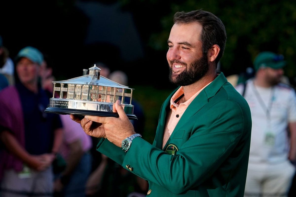 Scottie Scheffler holds up his trophy at the green jacket ceremony after winning the Masters on April 14, 2024.