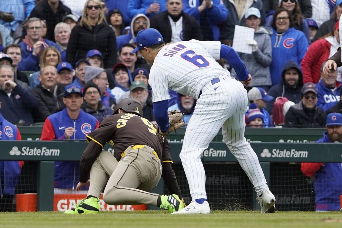 Apr 4, 2025; Chicago, Illinois, USA; Chicago Cubs third baseman Matt Shaw (6) tags out San Diego Padres first baseman Jake Cronenworth (9) at third base during the fifth inning at Wrigley Field. Mandatory Credit: David Banks-Imagn Images