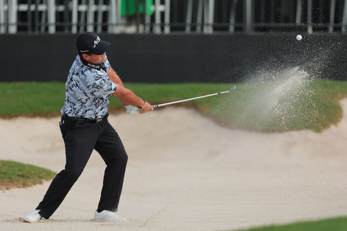 Apr 4, 2025; Miami, Florida, USA; Patrick Reed plays a shot from a bunker on the ninth hole during the first round of the LIV Golf Miami golf tournament at Trump National Doral. Mandatory Credit: Sam Navarro-Imagn Images