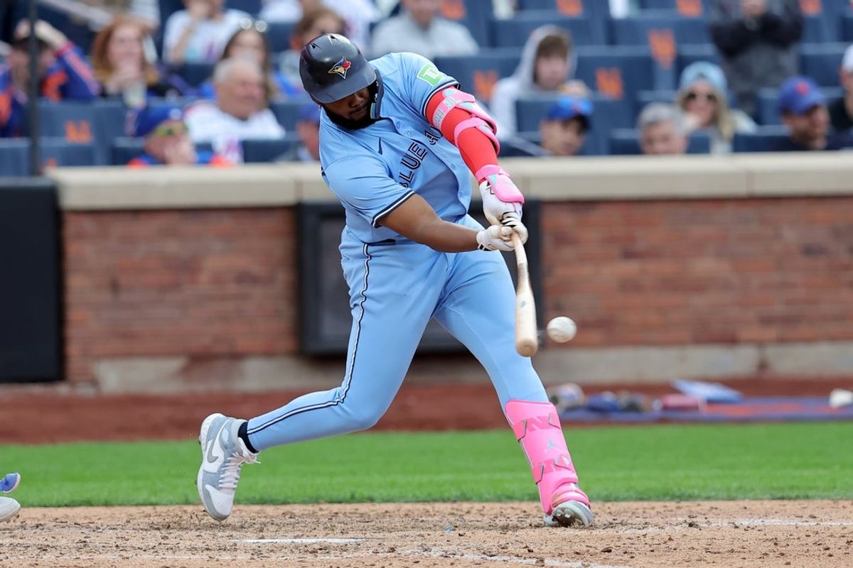 Apr 4, 2025; New York City, New York, USA; Toronto Blue Jays first baseman Vladimir Guerrero Jr. (27) hits a single during the eighth inning against the New York Mets at Citi Field. Mandatory Credit: Brad Penner-Imagn Images