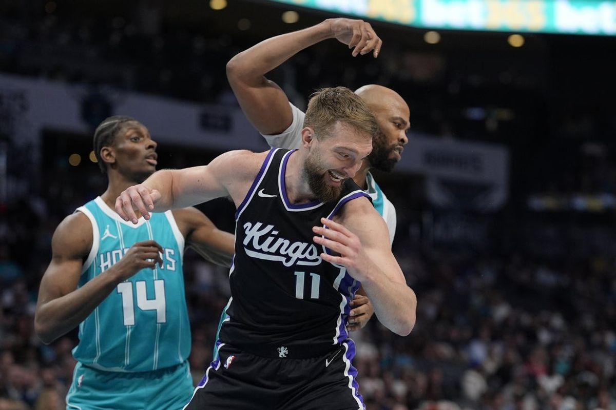 Apr 4, 2025; Charlotte, North Carolina, USA; Sacramento Kings forward Domantas Sabonis (11) is fouled by Charlotte Hornets forward Taj Gibson (67) during the second quarter at Spectrum Center. Mandatory Credit: Jim Dedmon-Imagn Images