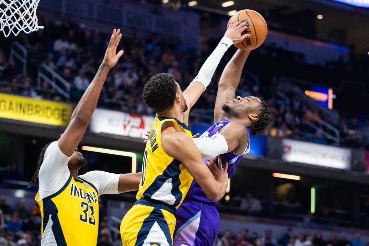 Apr 4, 2025; Indianapolis, Indiana, USA; Indiana Pacers guard Tyrese Haliburton (0) blocks the shot of Utah Jazz guard Isaiah Collier (13) in the first half at Gainbridge Fieldhouse. Mandatory Credit: Trevor Ruszkowski-Imagn Images