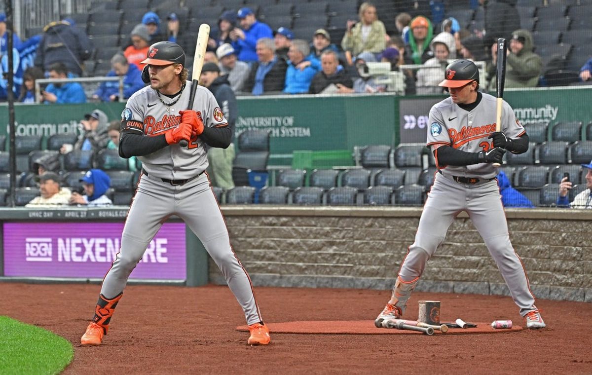 Apr 4, 2025; Kansas City, Missouri, USA;  Baltimore Orioles shortstop Gunnar Henderson (2) and catcher Adley Rutschman (35) in the on deck circle before the game aganst the Kansas City Royals at Kauffman Stadium. Mandatory Credit: Peter Aiken-Imagn Images