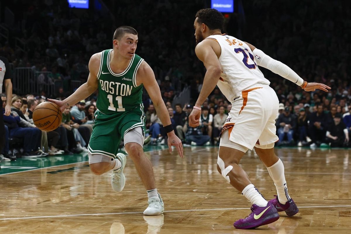 Apr 4, 2025; Boston, Massachusetts, USA; Boston Celtics guard Payton Pritchard (11) looks for an opening around Phoenix Suns guard Tyus Jones (21) during the second quarter at TD Garden. Mandatory Credit: Winslow Townson-Imagn Images