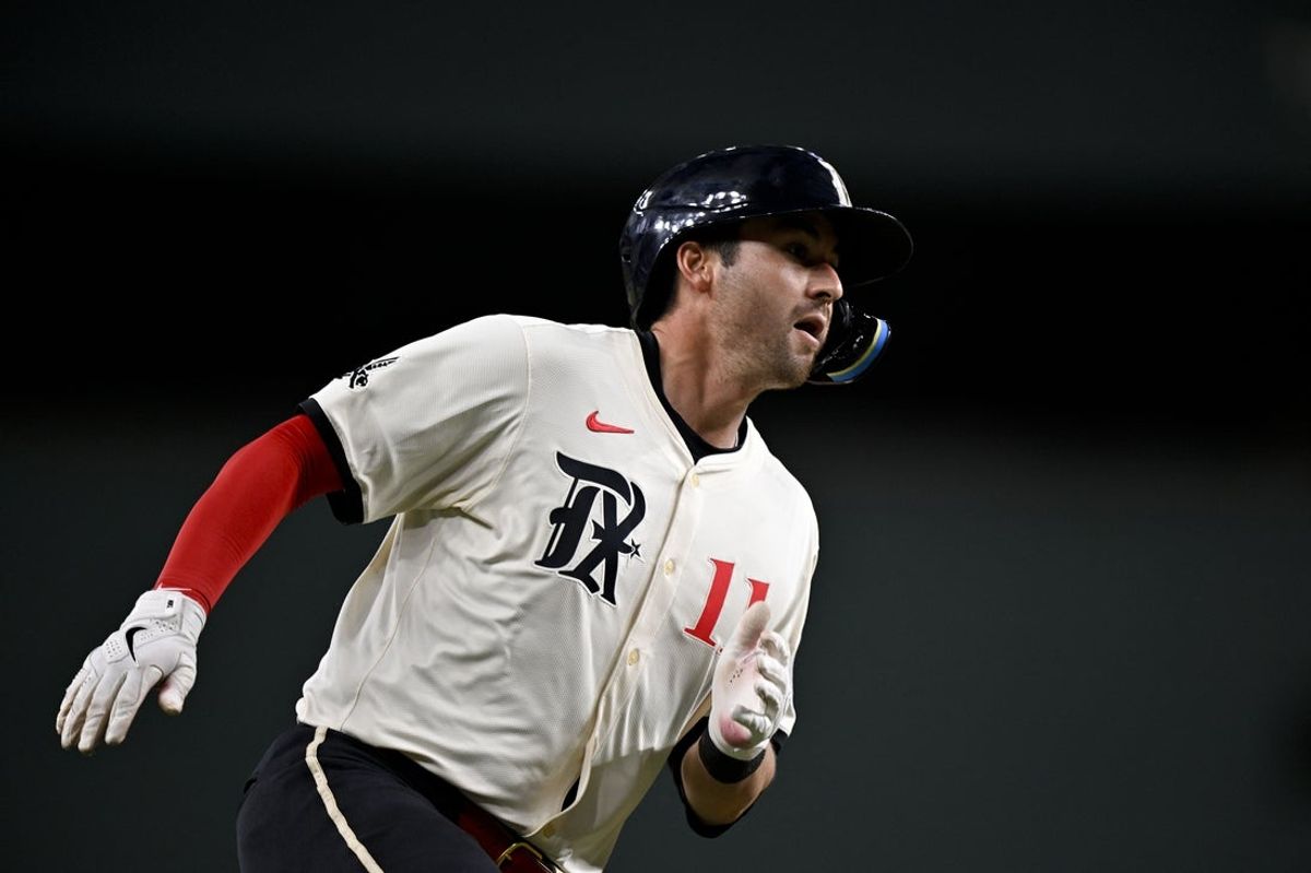 Apr 4, 2025; Arlington, Texas, USA; Texas Rangers catcher Kyle Higashioka (11) scores on a single hit by Texas Rangers center fielder Leody Taveras (not pictured) during the third inning against the Tampa Bay Rays at Globe Life Field. Mandatory Credit: Jerome Miron-Imagn Images