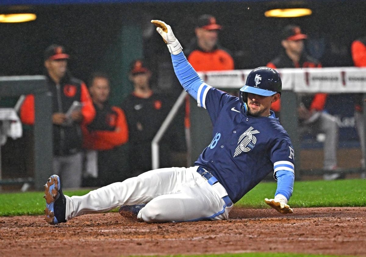 Apr 4, 2025; Kansas City, Missouri, USA;  Kansas City Royals designated hitter Cavan Biggio (18) slides home to score a run in the fourth inning against the Baltimore Orioles at Kauffman Stadium. Mandatory Credit: Peter Aiken-Imagn Images