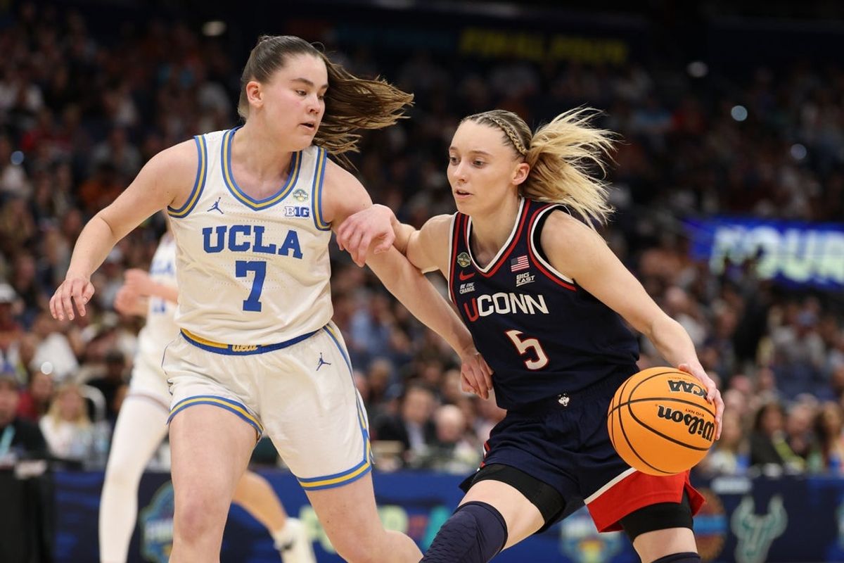 Apr 4, 2025; Tampa, FL, USA;  Connecticut Huskies guard Paige Bueckers (5) dribbles against UCLA Bruins guard Elina Aarnisalo (7) during the third quarter in a semifinal of the women's 2025 NCAA tournament at Amalie Arena. Mandatory Credit: Nathan Ray Seebeck-Imagn Images