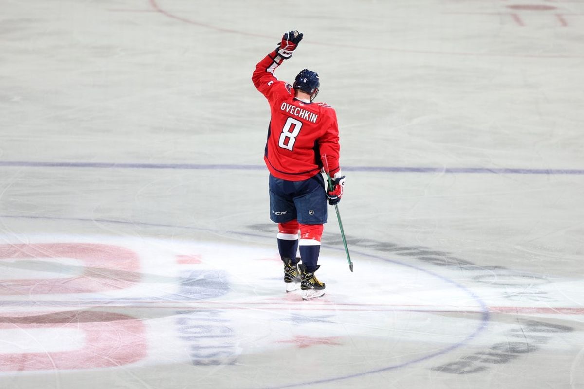 Apr 4, 2025; Washington, District of Columbia, USA; Washington Capitals left wing Alex Ovechkin (8) waves to fans in the stands after scoring a goal against the Chicago Blackhawks in the third period at Capital One Arena. The goal is the 894th of his career, tying Wayne Gretzky (not pictured) for most all-time goals scored in the NHL. Mandatory Credit: Amber Searls-Imagn Images