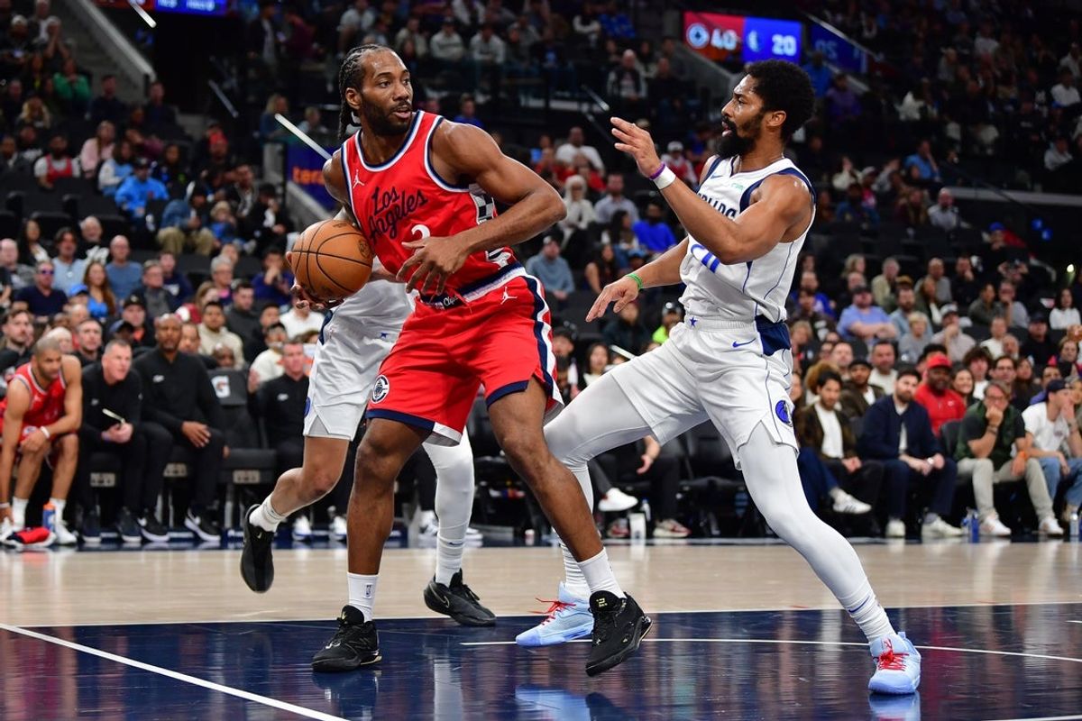 Apr 4, 2025; Inglewood, California, USA; Los Angeles Clippers forward Kawhi Leonard (2) moves the ball against Dallas Mavericks guard Spencer Dinwiddie (26) during the first half at Intuit Dome. Mandatory Credit: Gary A. Vasquez-Imagn Images
