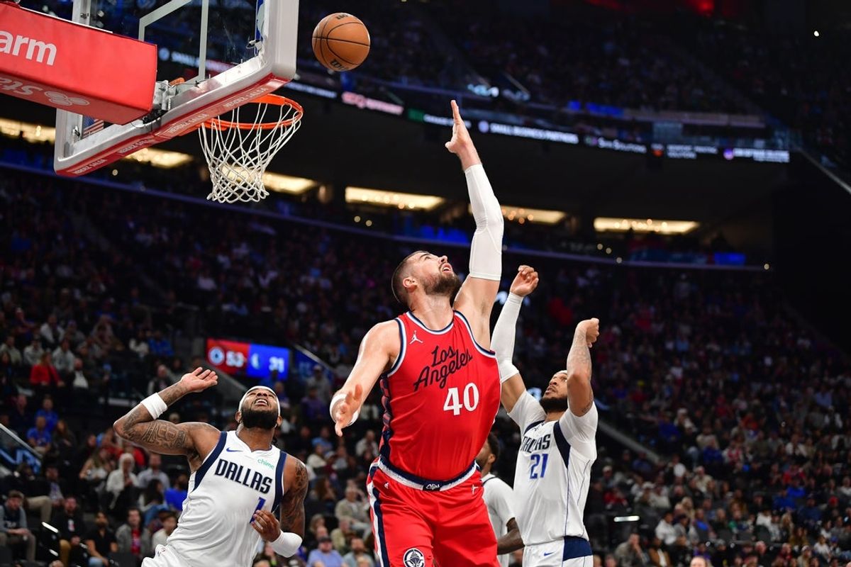 Apr 4, 2025; Inglewood, California, USA; Los Angeles Clippers center Ivica Zubac (40) plays for the rebound against Dallas Mavericks guard Jaden Hardy (1) and center Daniel Gafford (21) during the first half at Intuit Dome. Mandatory Credit: Gary A. Vasquez-Imagn Images