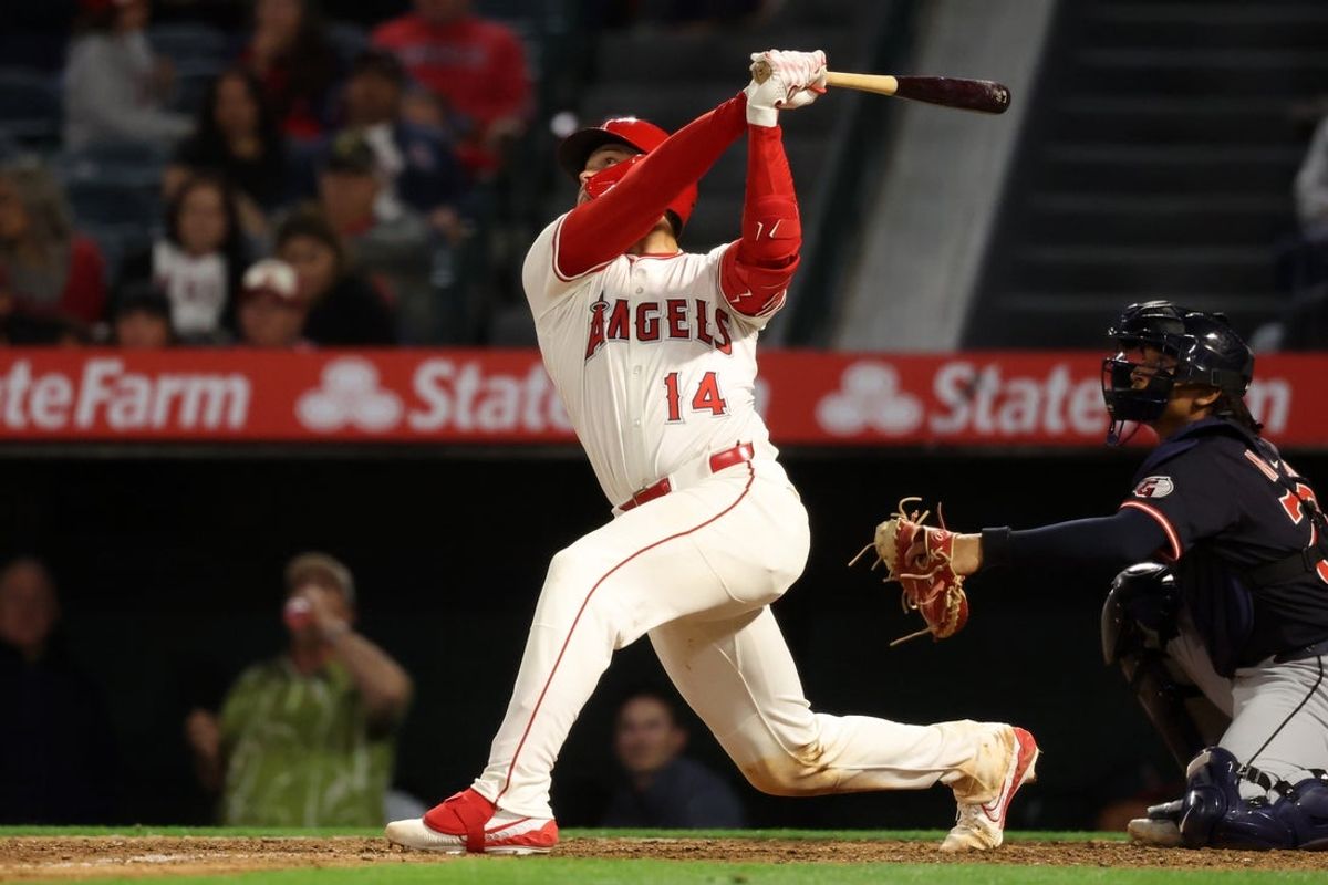 Apr 4, 2025; Anaheim, California, USA;  Los Angeles Angels catcher Logan O'Hoppe (14) hits a single during the seventh inning against the Cleveland Guardians at Angel Stadium. Mandatory Credit: Kiyoshi Mio-Imagn Images