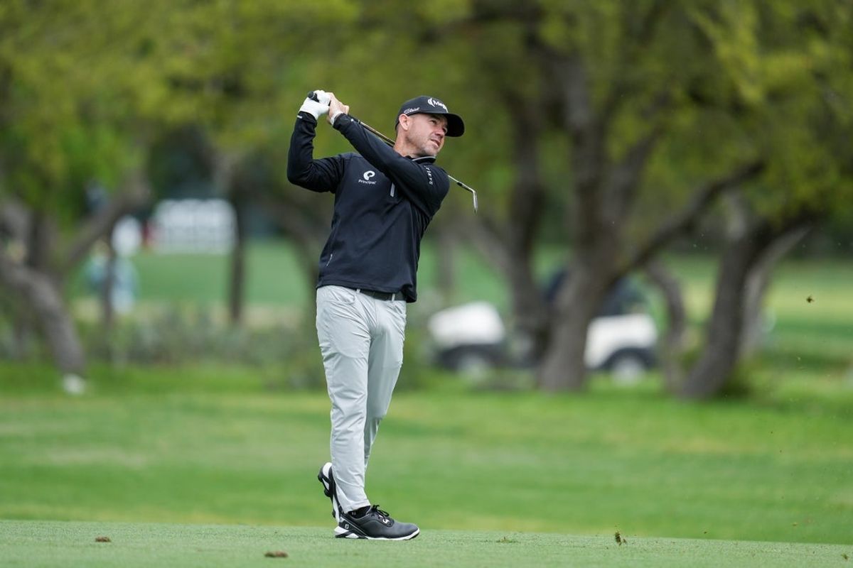 Apr 5, 2025; San Antonio, Texas, USA; Brian Harman watches his shot on the first hole during the third round of the Valero Texas Open golf tournament. Mandatory Credit: Daniel Dunn-Imagn Images