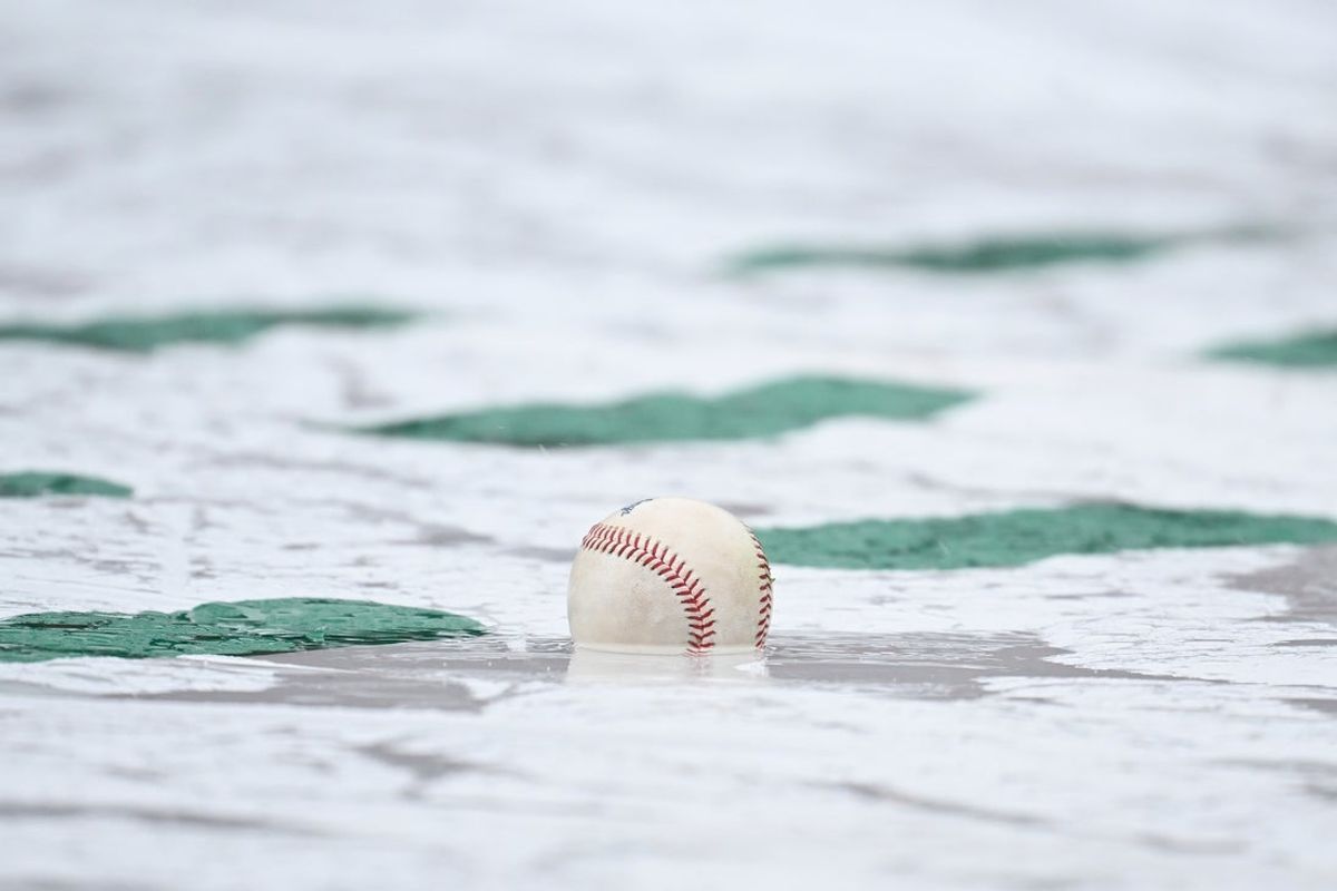 Apr 5, 2025; Boston, Massachusetts, USA; A baseball sits in a puddle on the rain tarps at Fenway Park before a game between the Boston Red Sox and the St. Louis Cardinals.. Mandatory Credit: Eric Canha-Imagn Images