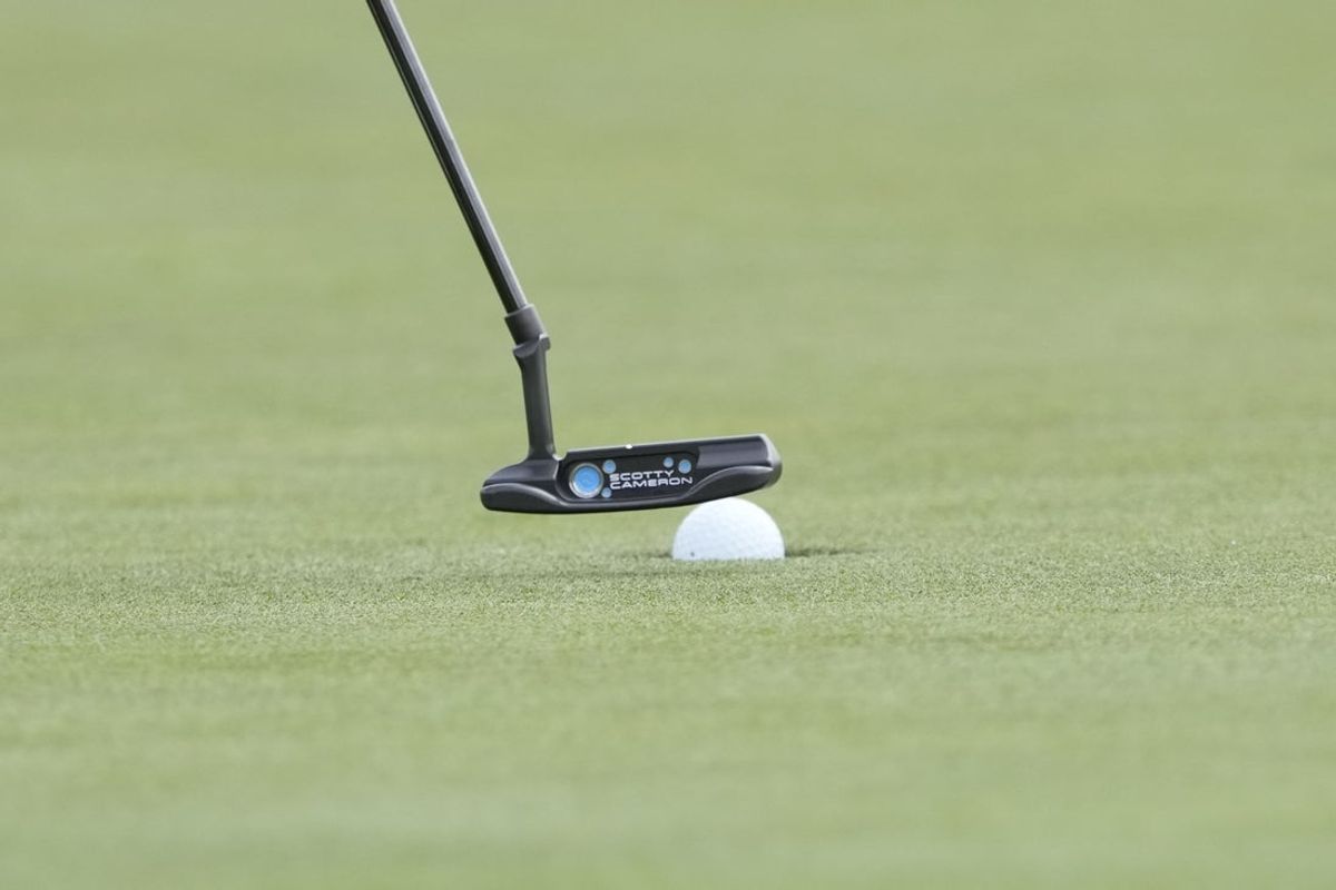 Apr 5, 2025; Augusta, Georgia, USA; Detail view of the ball and putter for Catherine Park on the 18th hole during the final round of the Augusta National Women's Amateur golf tournament at Augusta National Golf Club. Mandatory Credit: Michael Madrid-Imagn Images