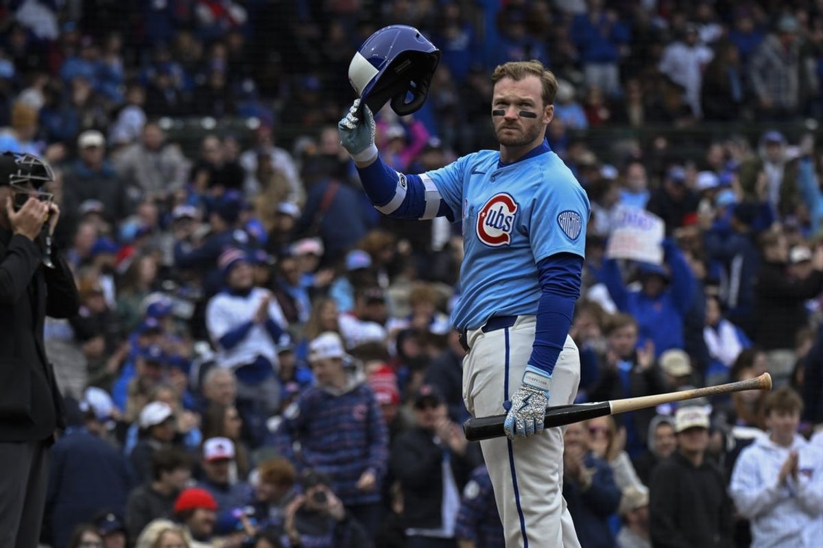 Apr 5, 2025; Chicago, Illinois, USA;  Chicago Cubs outfielder Ian Happ (8) acknowledges fans after being recognized for playing 1000 games before batting against the San Diego Padres during the first inning at Wrigley Field. Mandatory Credit: Matt Marton-Imagn Images