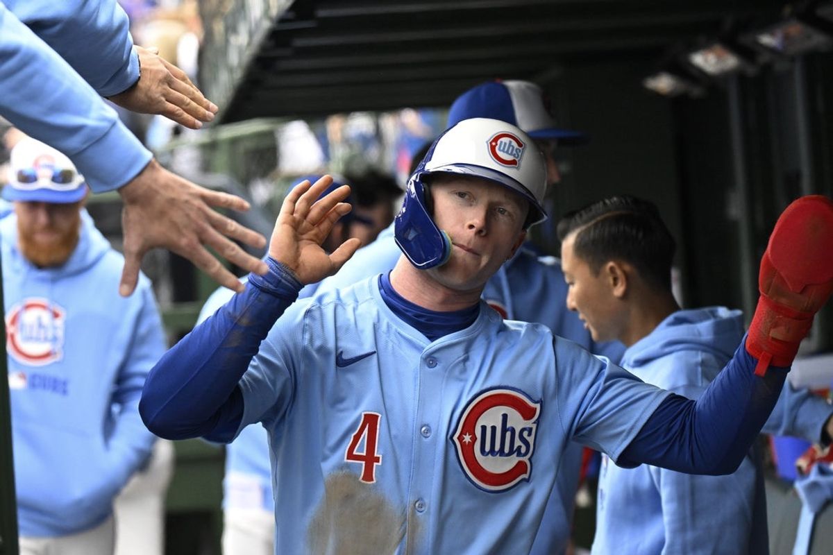 Apr 5, 2025; Chicago, Illinois, USA;  Chicago Cubs outfielder Pete Crow-Armstrong (4) celebrates in the dugout after scoring during the second inning against the San Diego Padres at Wrigley Field. Mandatory Credit: Matt Marton-Imagn Images