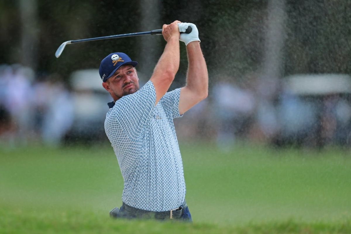 Apr 5, 2025; Miami, Florida, USA; Bryson DeChambeau plays a shot from a bunker on the tenth hole during the second round of the LIV Golf Miami golf tournament at Trump National Doral. Mandatory Credit: Sam Navarro-Imagn Images