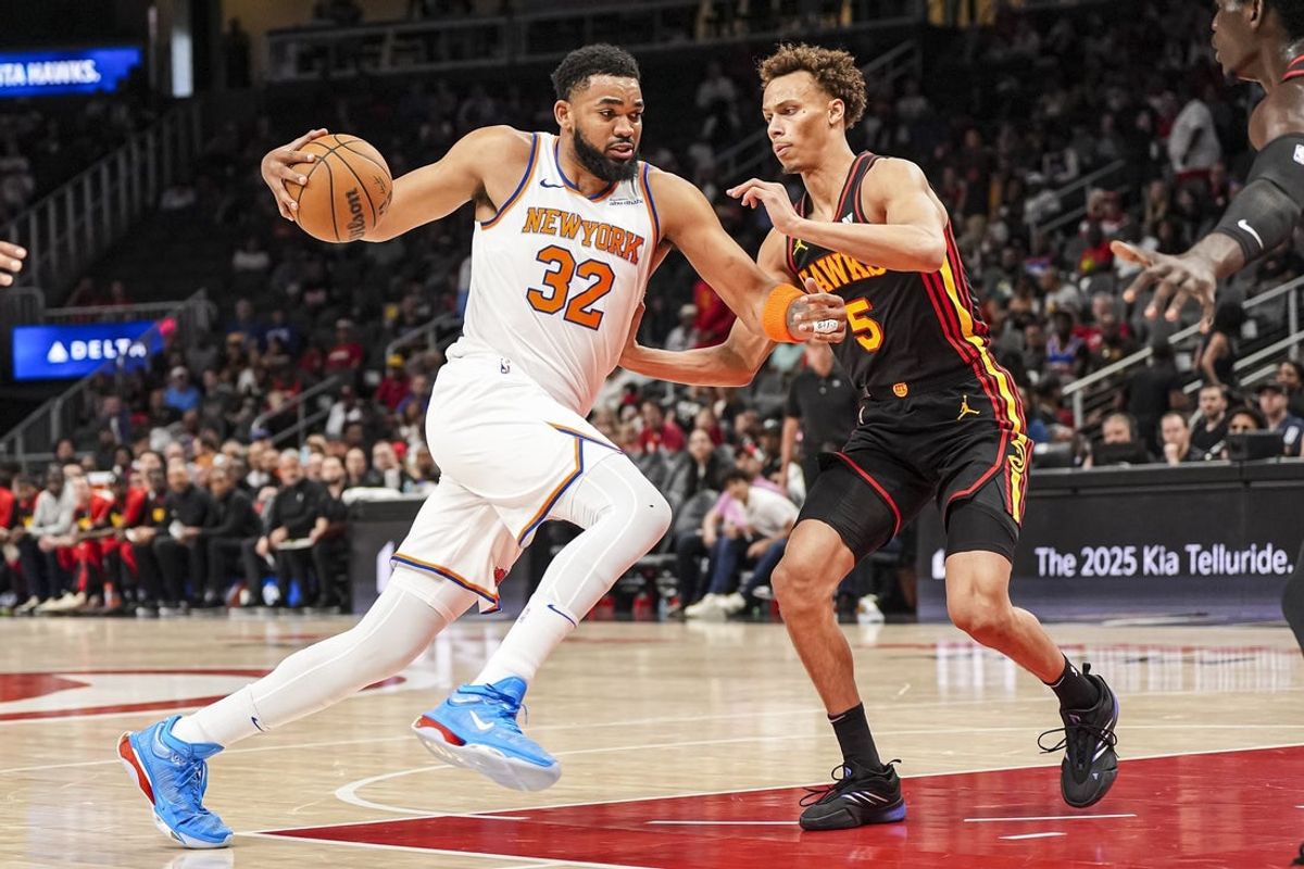 Apr 5, 2025; Atlanta, Georgia, USA; New York Knicks center Karl-Anthony Towns (32) dribbles against Atlanta Hawks guard Dyson Daniels (5) during the first half at State Farm Arena. Mandatory Credit: Dale Zanine-Imagn Images