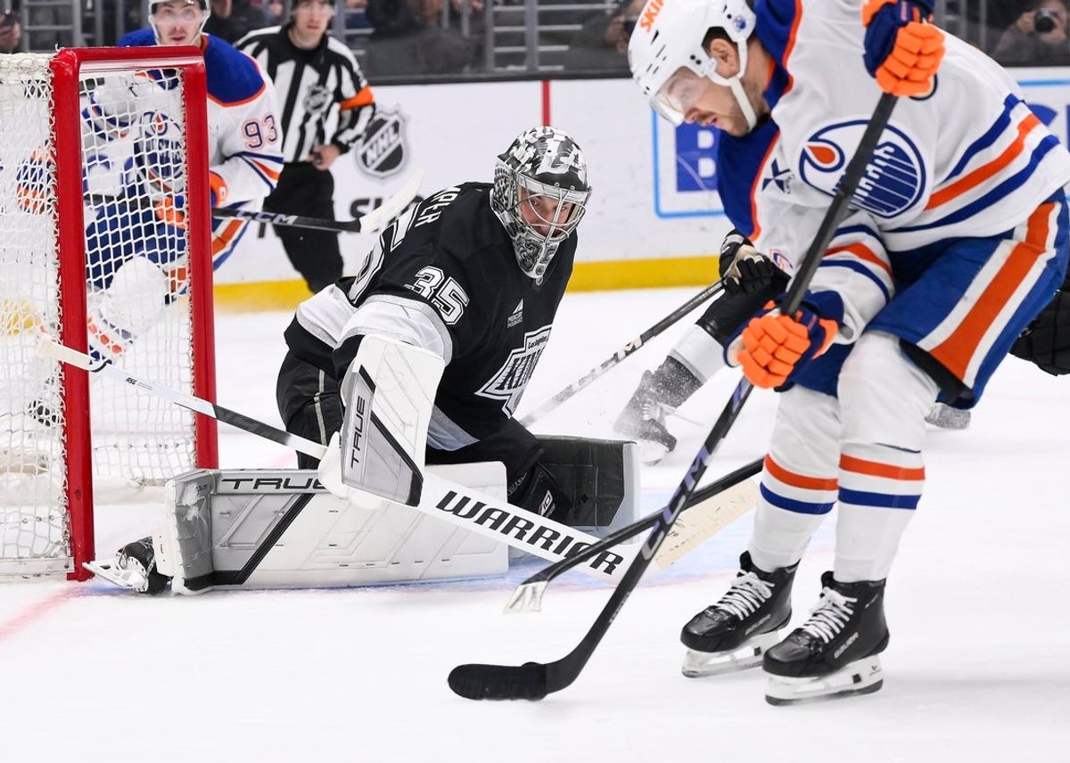 Apr 5, 2025; Los Angeles, California, USA; Edmonton Oilers left wing Viktor Arvidsson (33) moves the puck to take a shot as Los Angeles Kings goaltender Darcy Kuemper (35) defends the goal during the first period at Crypto.com Arena. Mandatory Credit: Robert Hanashiro-Imagn Images