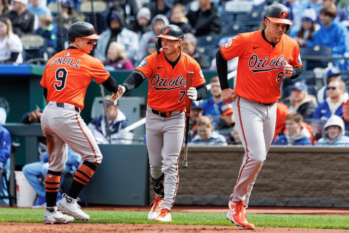 Apr 5, 2025; Kansas City, Missouri, USA; Baltimore Orioles second baseman Jackson Holliday (7) reacts with Baltimore Orioles outfielder Tyler O'Neill (9) and first baseman Ryan Mountcastle (6) after scoring during the second inning against the Kansas City Royals at Kauffman Stadium. Mandatory Credit: William Purnell-Imagn Images