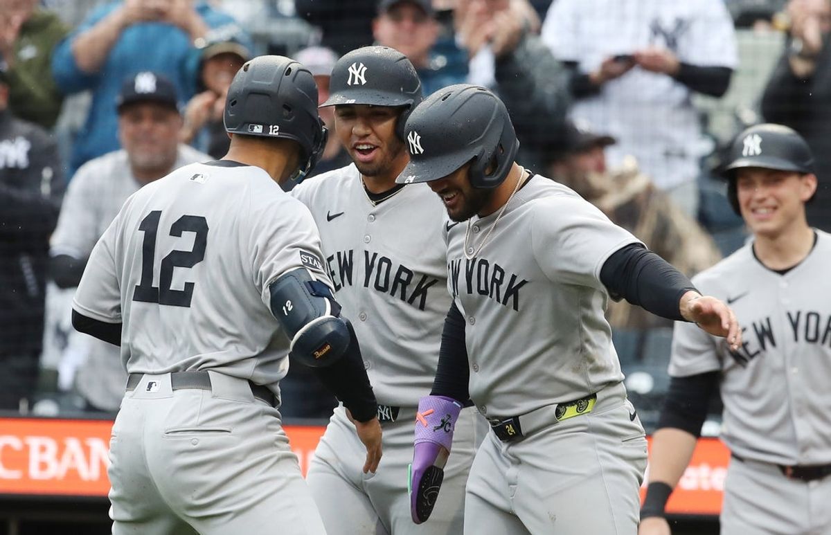 Apr 5, 2025; Pittsburgh, Pennsylvania, USA;  New York Yankees center fielder Trent Grisham (12) celebrates his second home run of the game with third baseman Oswald Peraza (middle) and left fielder Jasson Dominguez (right) against the Pittsburgh Pirates during the fifth inning at PNC Park. Mandatory Credit: Charles LeClaire-Imagn Images