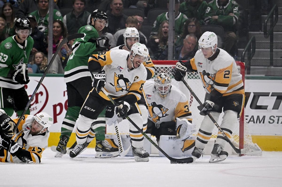 Apr 5, 2025; Dallas, Texas, USA; Pittsburgh Penguins center Sidney Crosby (87) scores a goal on an empty net for a hat trick against the Dallas Stars during the third period at the American Airlines Center. Mandatory Credit: Jerome Miron-Imagn Images