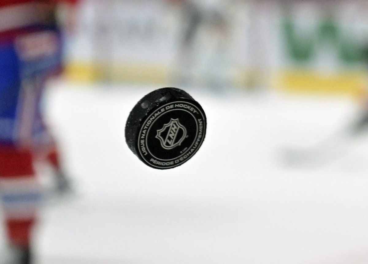 Apr 5, 2025; Montreal, Quebec, CAN; French logo on an NHL puck during the warmup period before the game between the Philadelphia Flyers and the Montreal Canadiens at the Bell Centre. Mandatory Credit: Eric Bolte-Imagn Images