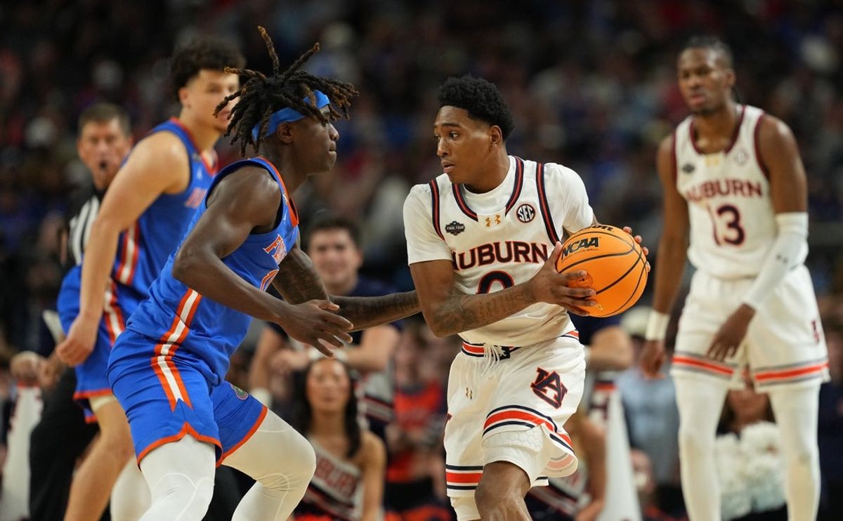 Apr 5, 2025; San Antonio, TX, USA; Auburn Tigers guard Tahaad Pettiford (0) controls the ball against Florida Gatorsguard Denzel Aberdeen (11) during the second half in the semifinals of the men's Final Four of the 2025 NCAA Tournament at the Alamodome. Mandatory Credit: Bob Donnan-Imagn Images
