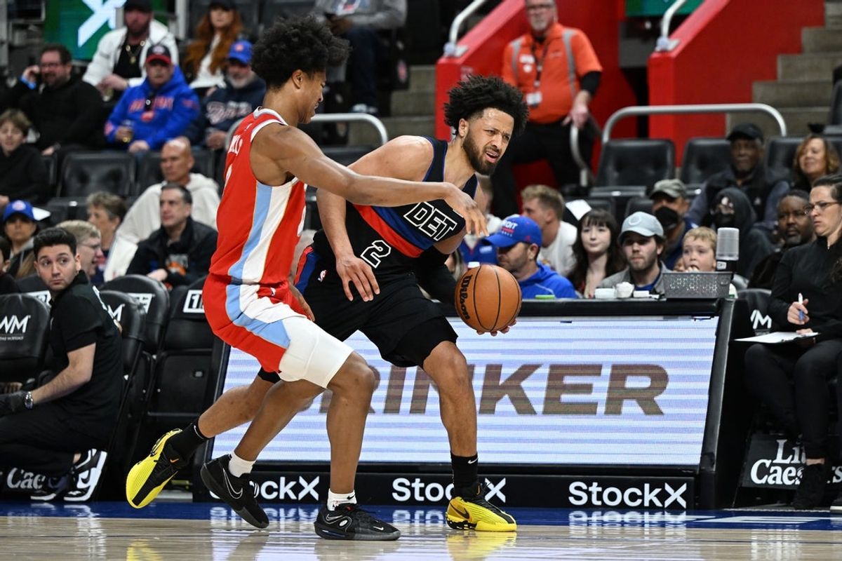 Apr 5, 2025; Detroit, Michigan, USA;  Detroit Pistons guard Cade Cunningham (2) tries to drive past Memphis Grizzlies forward Jaylen Wells (0) in the first quarter at Little Caesars Arena. Mandatory Credit: Lon Horwedel-Imagn Images