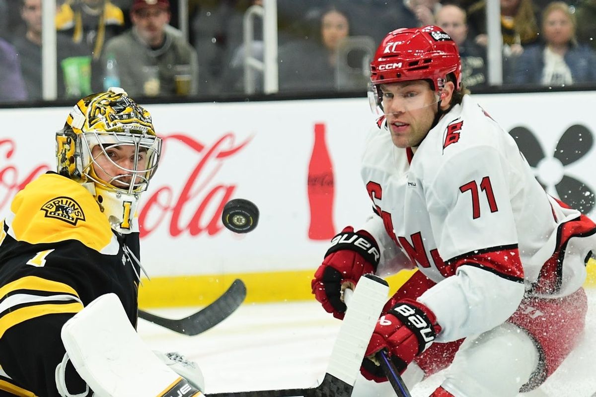 Apr 5, 2025; Boston, Massachusetts, USA; Boston Bruins goaltender Jeremy Swayman (1) deflects the puck away while Carolina Hurricanes left wing Taylor Hall (71) looks for the rebound during the second period at TD Garden. Mandatory Credit: Bob DeChiara-Imagn Images
