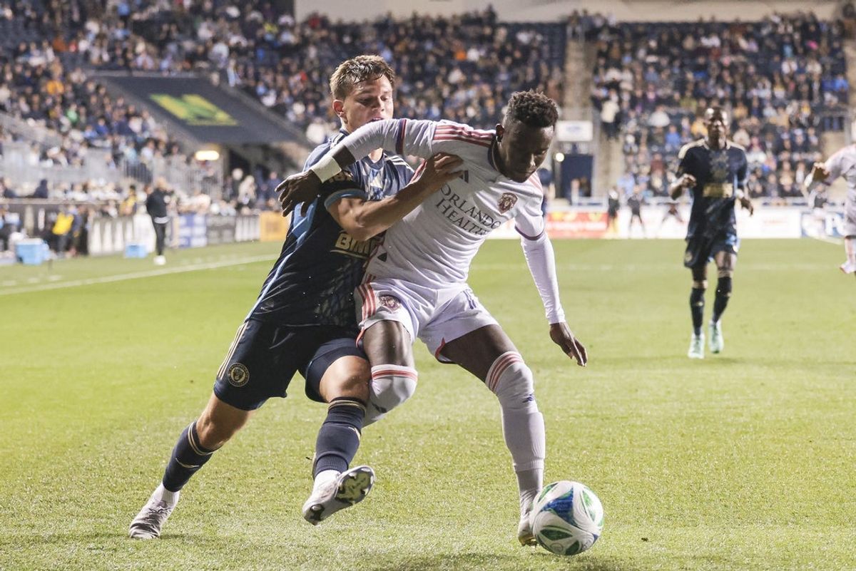 Apr 5, 2025; Chester, Pennsylvania, USA; Philadelphia Union defender Frankie Westfield (39) battles for the ball against Orlando City SC forward Iván Angulo (77) during the first half at Subaru Park. Mandatory Credit: Luther Schlaifer-Imagn Images