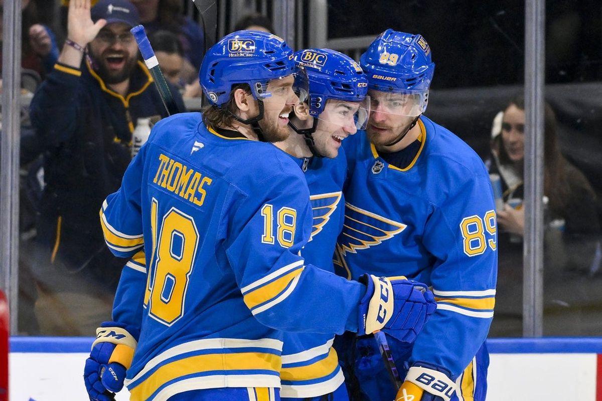 Apr 5, 2025; St. Louis, Missouri, USA;  St. Louis Blues left wing Pavel Buchnevich (89) celebrates with right wing Jimmy Snuggerud (21) and center Robert Thomas (18) after scoring against the Colorado Avalanche during the second period at Enterprise Center. Mandatory Credit: Jeff Curry-Imagn Images