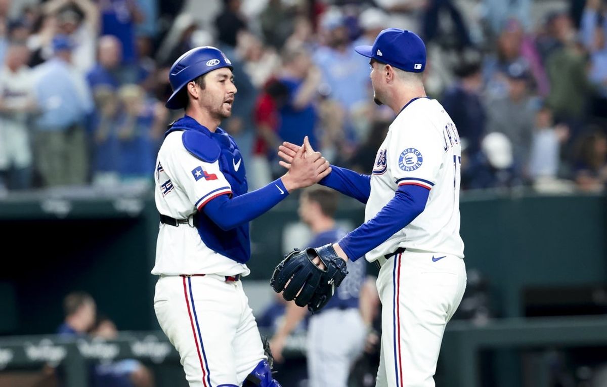 Apr 5, 2025; Arlington, Texas, USA; Texas Rangers relief pitcher Luke Jackson (77) celebrates with Texas Rangers catcher Kyle Higashioka (11) after the game against the Tampa Bay Rays at Globe Life Field. Mandatory Credit: Kevin Jairaj-Imagn Images