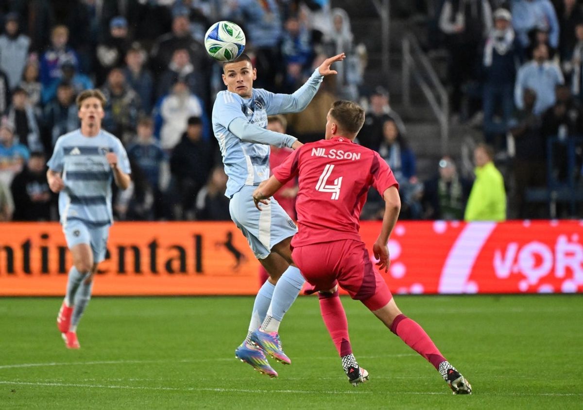 Apr 5, 2025; Kansas City, Kansas, USA;  Sporting Kansas City forward Dejan Joveljic (9) heads the ball against St. Louis City defender Joakim Nilsson (4) in the first half at Children's Mercy Park. Mandatory Credit: Peter Aiken-Imagn Images