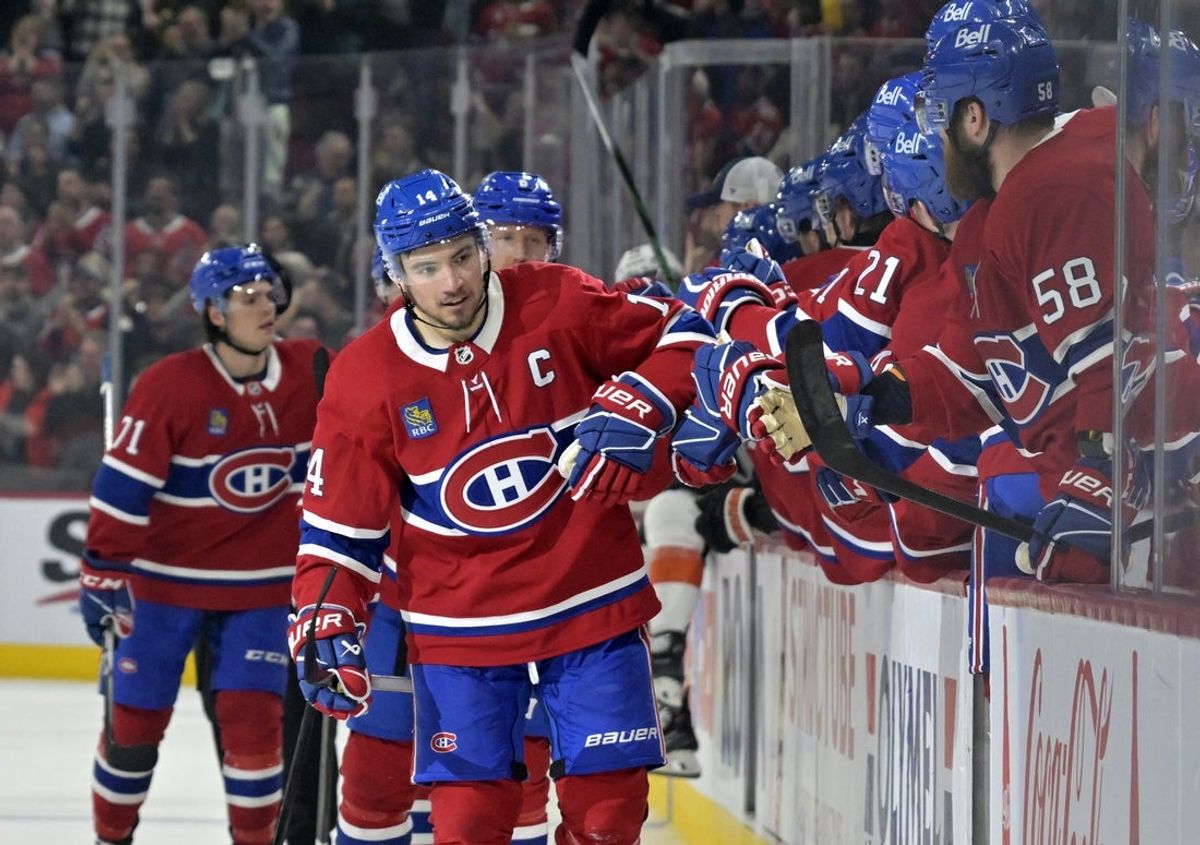 Apr 5, 2025; Montreal, Quebec, CAN; Montreal Canadiens forward Nick Suzuki (14) celebrates with teammates after scoring a goal against the Philadelphia Flyers during the third period at the Bell Centre. Mandatory Credit: Eric Bolte-Imagn Images