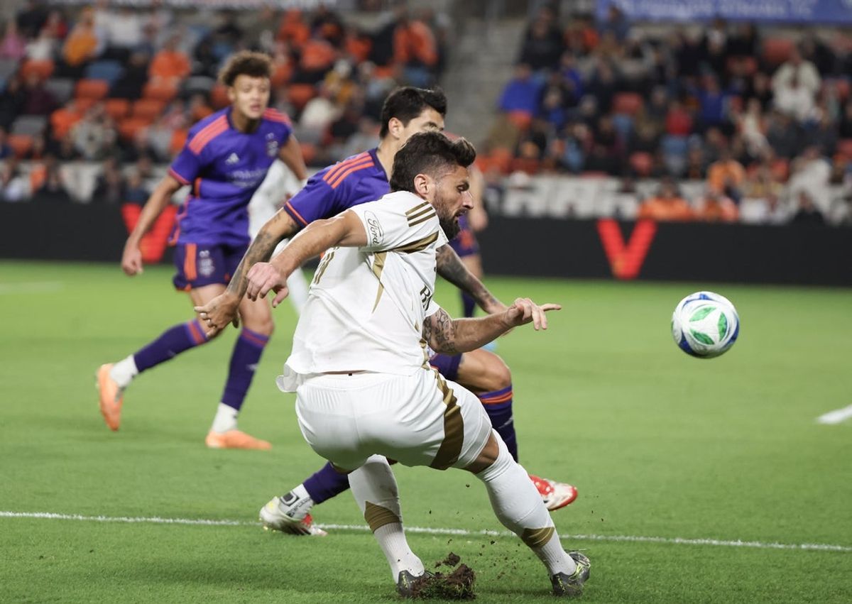 Apr 5, 2025; Houston, Texas, USA; Los Angeles FC forward Olivier Giroud (9) crosses the ball against Houston Dynamo FC defender Franco Escobar (2) in the first half at Shell Energy Stadium. Mandatory Credit: Thomas Shea-Imagn Images