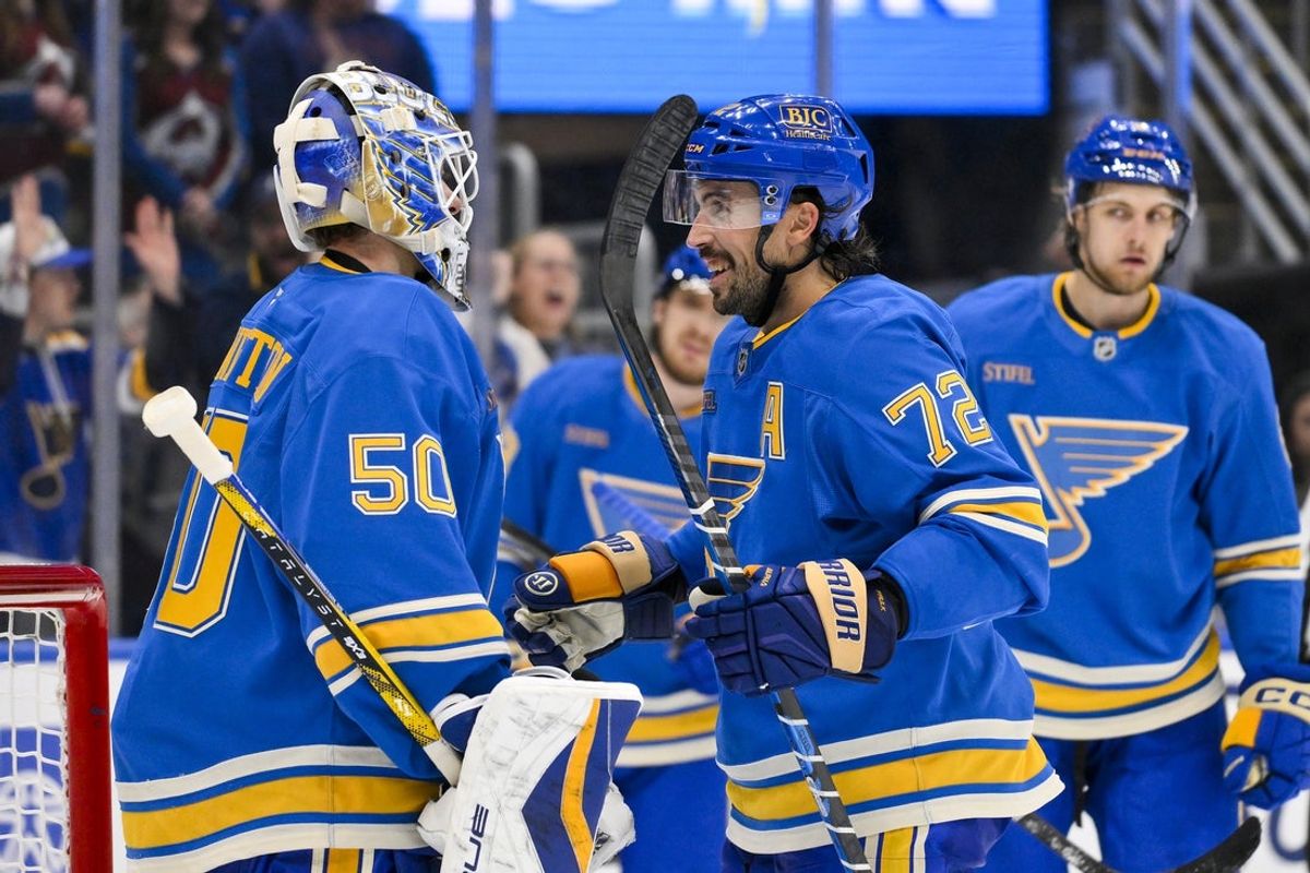 Apr 5, 2025; St. Louis, Missouri, USA;  St. Louis Blues goaltender Jordan Binnington (50) and defenseman Justin Faulk (72) celebrate after the Blues won their franchise record 12th straight win after a victory over the Colorado Avalanche at Enterprise Center. Mandatory Credit: Jeff Curry-Imagn Images