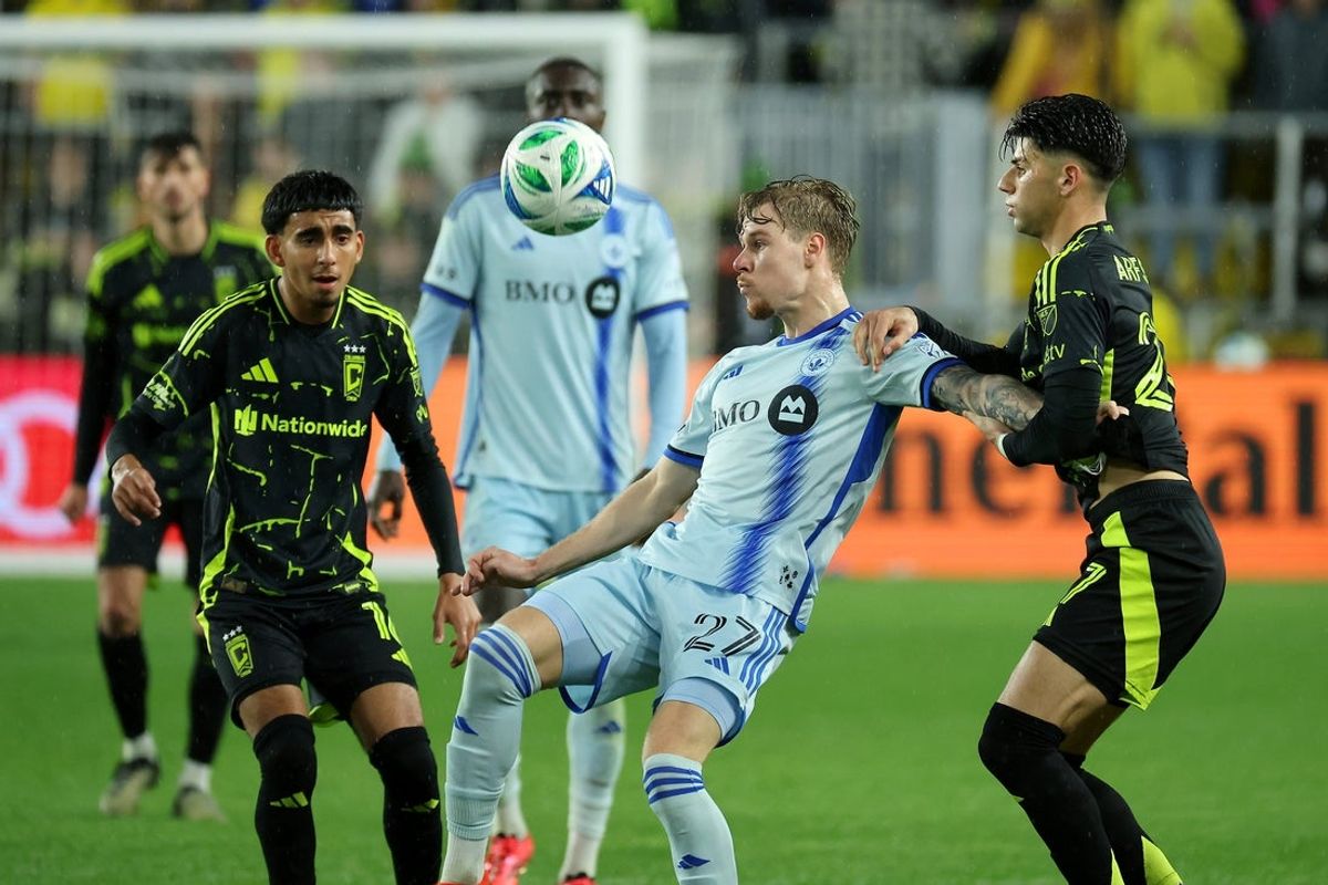 Apr 5, 2025; Columbus, Ohio, USA;  CF Montréal defender Dawid Bugaj (27) fights for the ball with Columbus Crew forward Max Arfsten (27) and midfielder Taha Habroune (16) during the second half at Lower.com Field. Mandatory Credit: Joseph Maiorana-Imagn Images