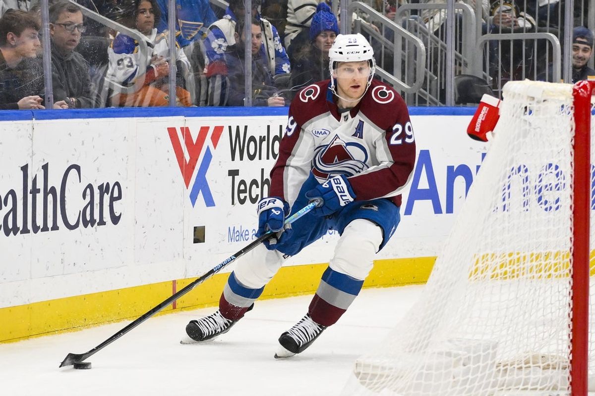 Apr 5, 2025; St. Louis, Missouri, USA;  Colorado Avalanche center Nathan MacKinnon (29) controls the puck against the St. Louis Blues during the third period at Enterprise Center. Mandatory Credit: Jeff Curry-Imagn Images