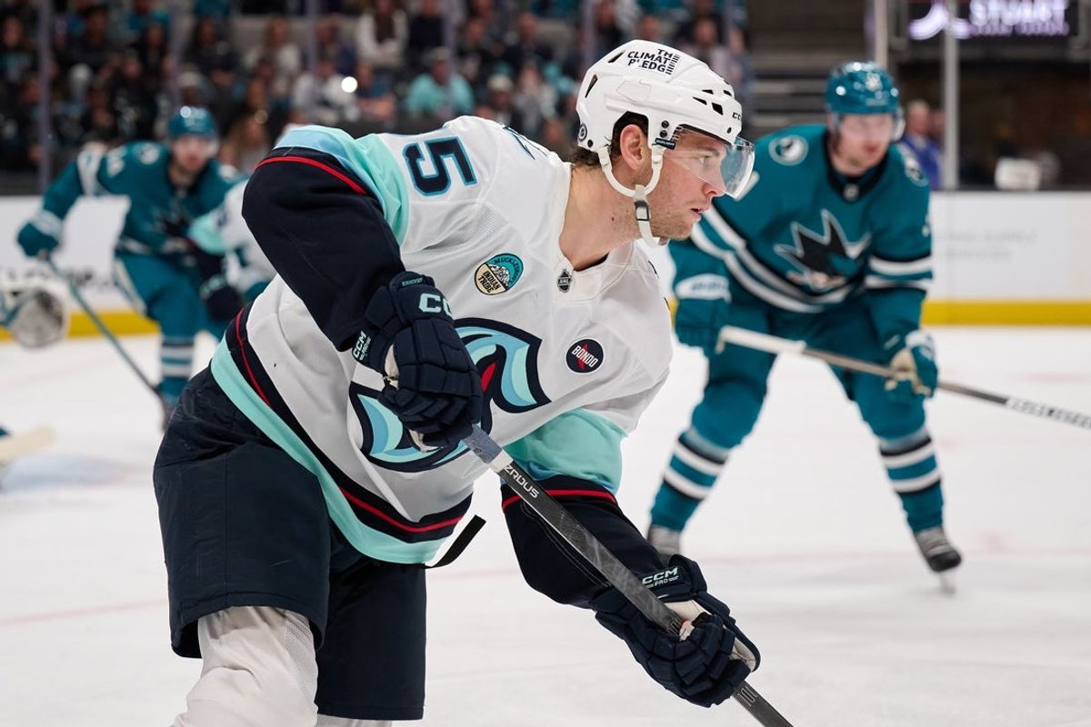 Apr 5, 2025; San Jose, California, USA; Seattle Kraken left wing Andre Burakovsky (95) plays the puck against the San Jose Sharks during the first period at SAP Center at San Jose. Mandatory Credit: Robert Edwards-Imagn Images